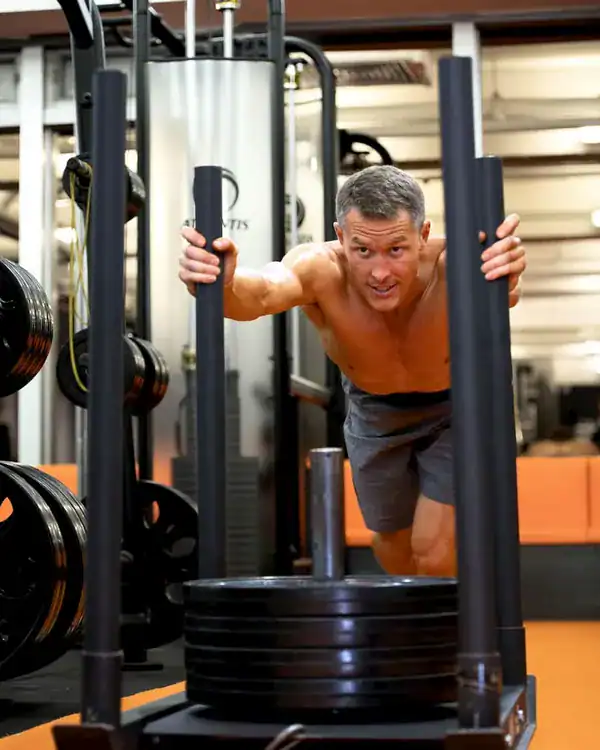 Damian Jacobs pushing a sled at ATP Personal Training Singapore